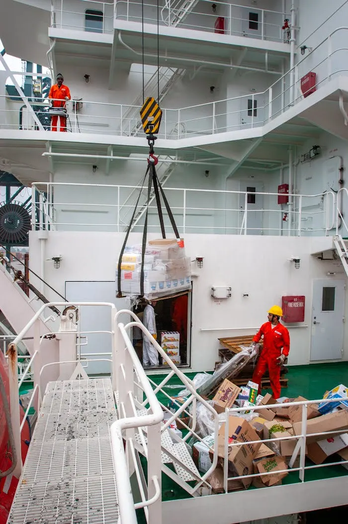 Crew transferring cargo on the deck of a ship