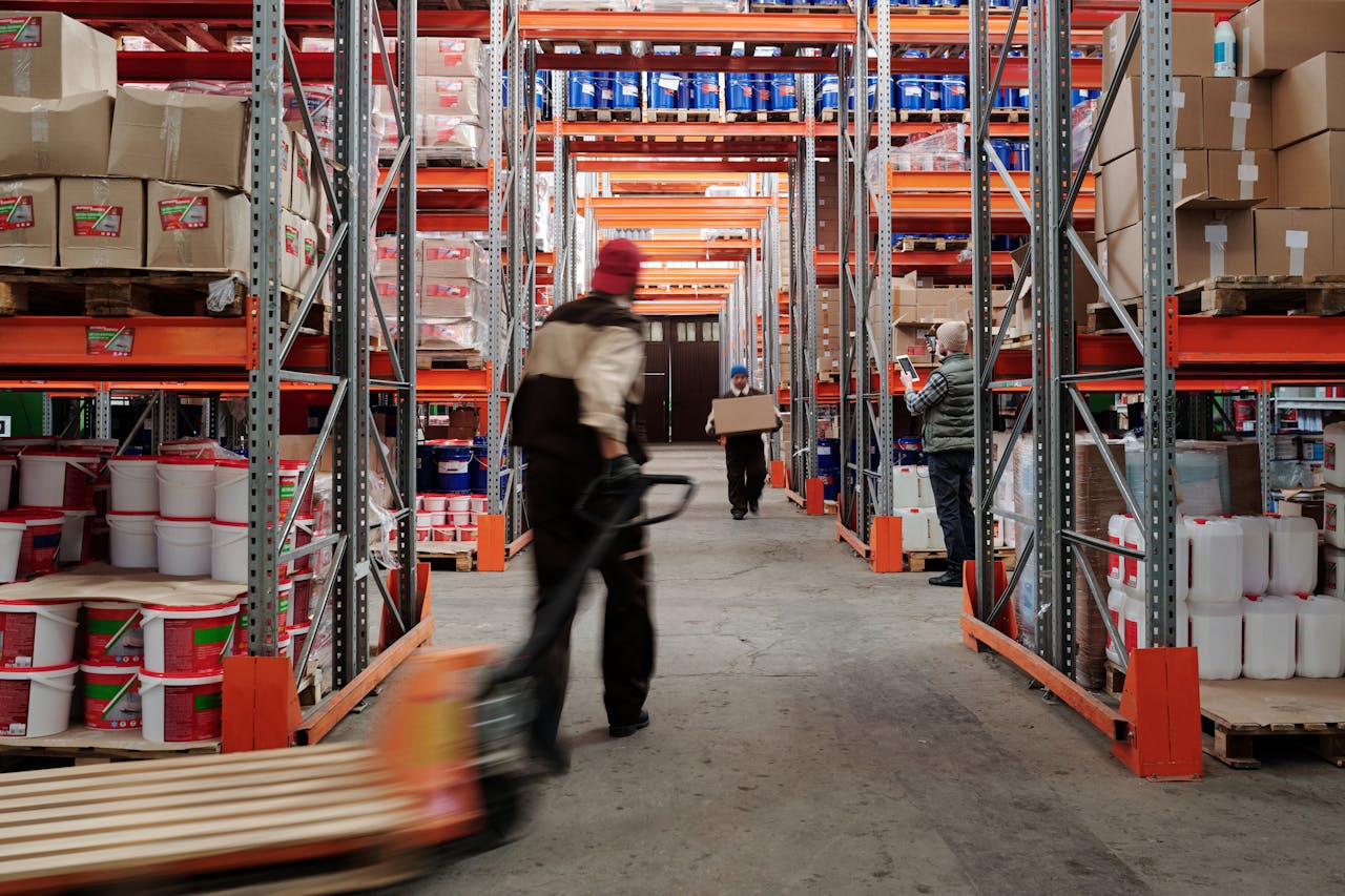 The Art of Drawing Readers In: Your attractive post title goes here Warehouse interior with workers organizing shelves full of boxes and containers.